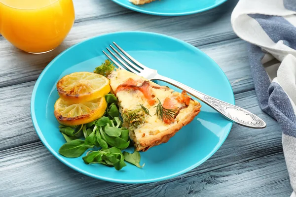 Prato com pedaço de torta de quiche de salmão na mesa — Fotografia de Stock