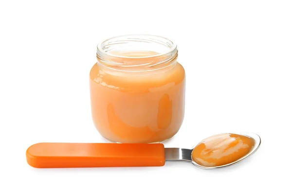 Spoon and jar with baby food — Stock Photo, Image