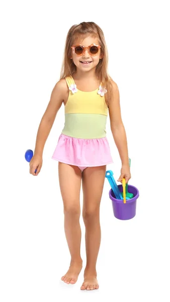 Adorable little girl in swimsuit with plastic toys on white background — Stock Photo, Image