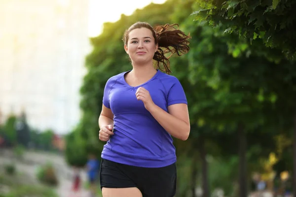 Mujer joven con sobrepeso trotando — Foto de Stock