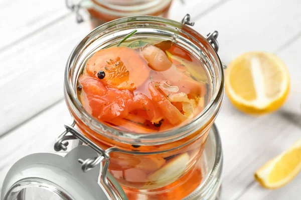 Jar with delicious marinated salmon — Stock Photo, Image