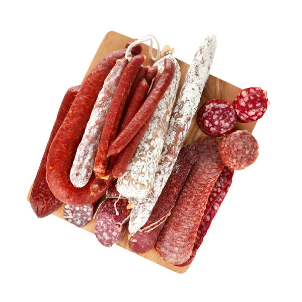 Assortment of sausages on wooden board, isolated on white — Stock Photo, Image