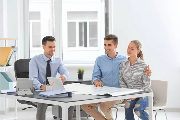 Real estate broker and customers discussing project of new flat — Stock Photo, Image