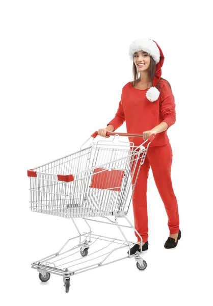 Young woman in Santa hat with  shopping cart on white background. Boxing day concept — Stock Photo, Image