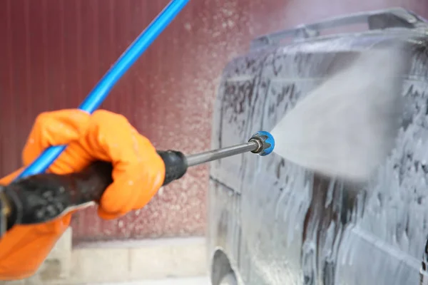 Man cleaning car with high pressure water — Stock Photo, Image