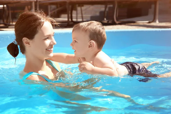 Gyermek medence leckét. Aranyos kisfiú megtanulni úszni, anya a medence — Stock Fotó