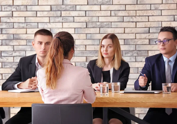 Human resources commission interviewing woman at table