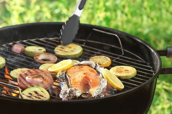 Приготовление вкусного стейка из лосося с овощами — стоковое фото