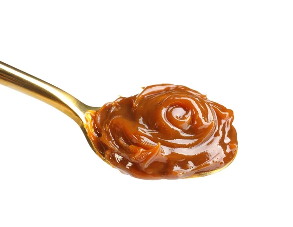 Cuchara con deliciosa salsa de caramelo sobre fondo blanco —  Fotos de Stock
