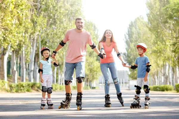 Family rollerskating in park Royalty Free Stock Photos