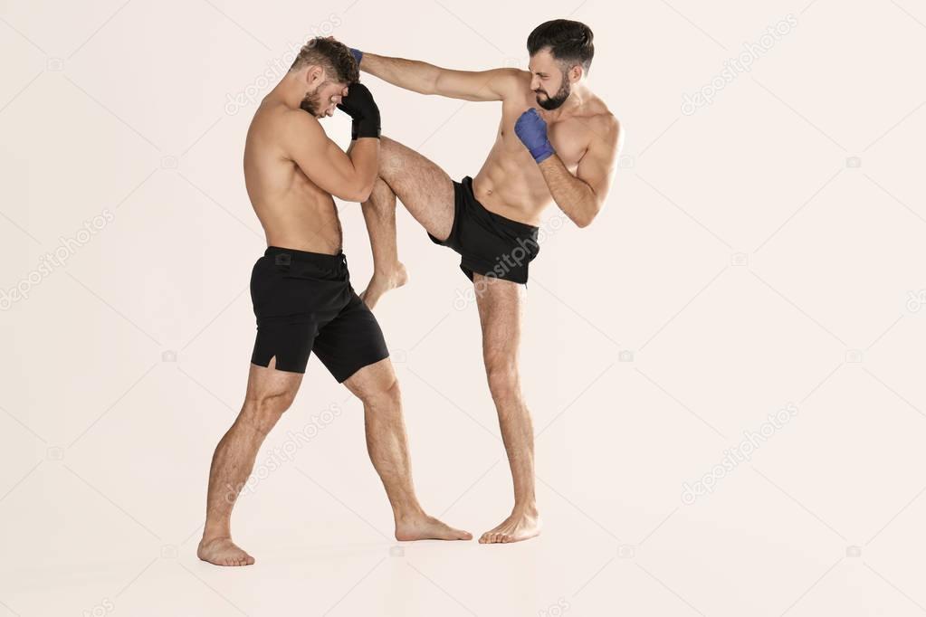 Male kickboxers fighting 