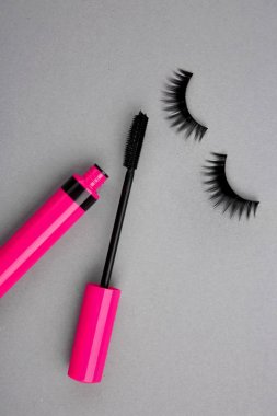 Rimel değnek ve gri arka plan üzerinde yanlış eyelashes