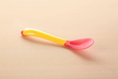 Ahşap masa üzerinde bebek için renkli kaşık