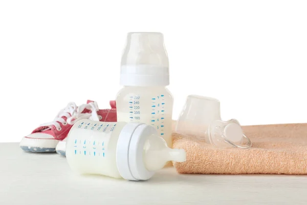 Composition with feeding bottles of baby milk formula on wooden table — Stock Photo, Image