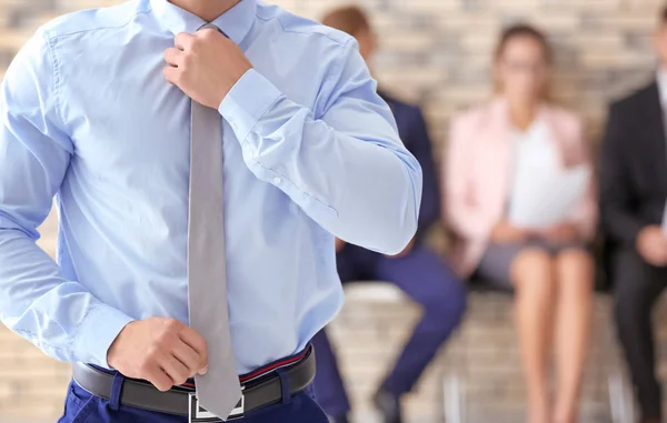 Young man and blurred people on background — Stock Photo, Image