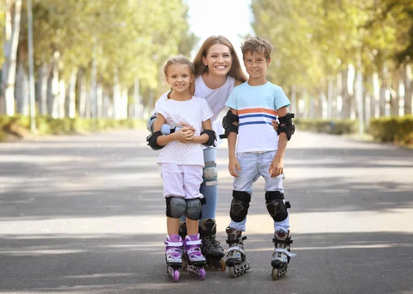 Madre con figlio e figlia pattinaggio nel parco — Foto Stock