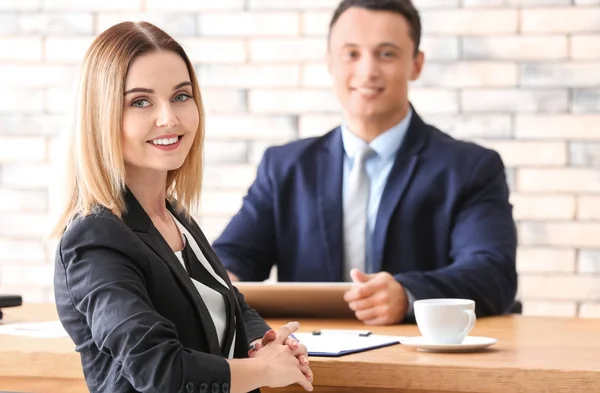 Human resources manager interviewing woman at table
