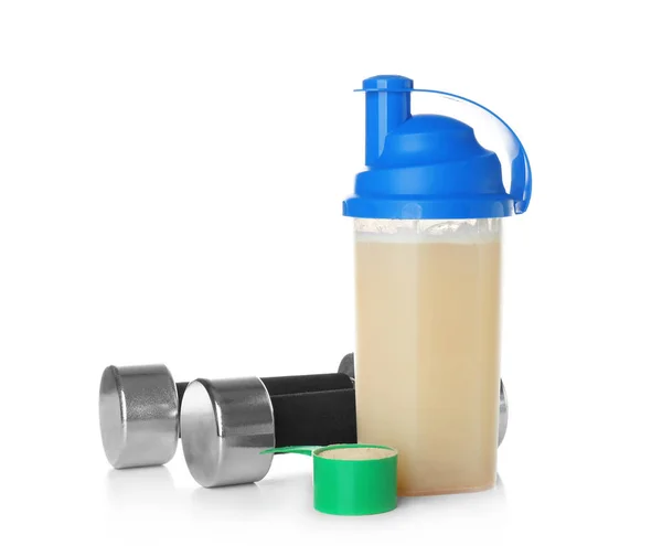Bottle with protein shake and dumbbells on white background — Stock Photo, Image