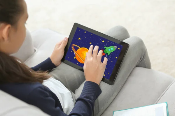 Teenage girl drawing on tablet at home