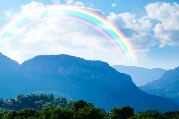 mountains and rainbow in sky