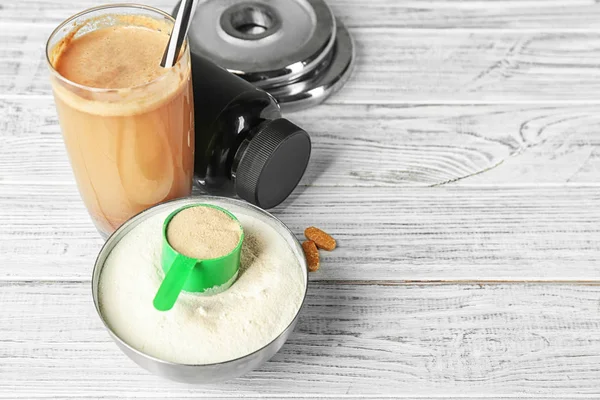 Glass with protein shake and powder on table — Stock Photo, Image