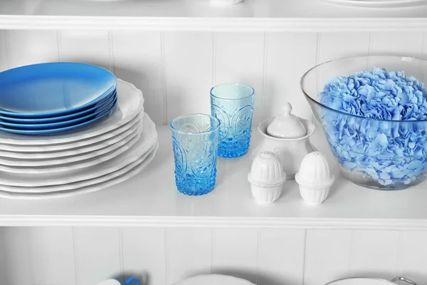 White storage stand with dishware in kitchen