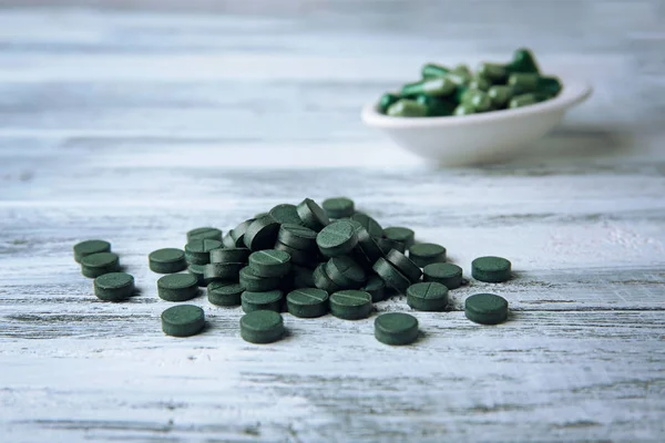 Pile of spirulina tablets on table — Stock Photo, Image