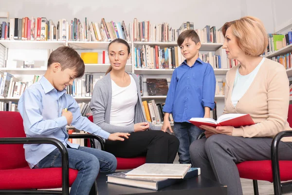 Young mother and children on meeting with teacher at school — Stock Photo, Image