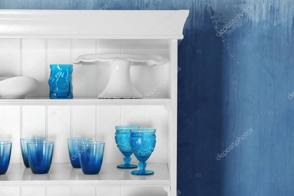 White storage stand with glassware in kitchen