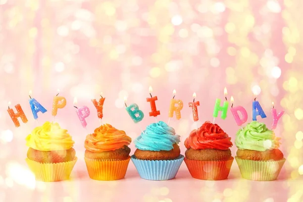 Rainbow cupcakes with candles — Stock Photo, Image