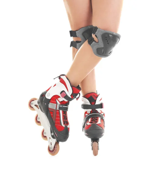 Legs of young woman on roller skates against white background — Stock Photo, Image