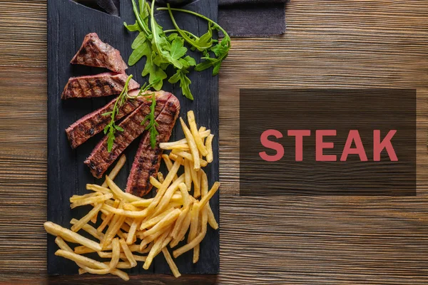 Pieces of delicious grilled steak and french fries — Stock Photo, Image