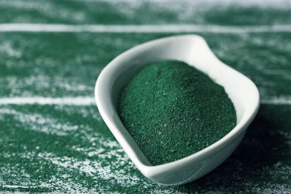 Placa y polvo de espirulina en la mesa — Foto de Stock