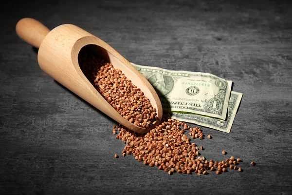 Raw buckwheat and money on table — Stock Photo, Image