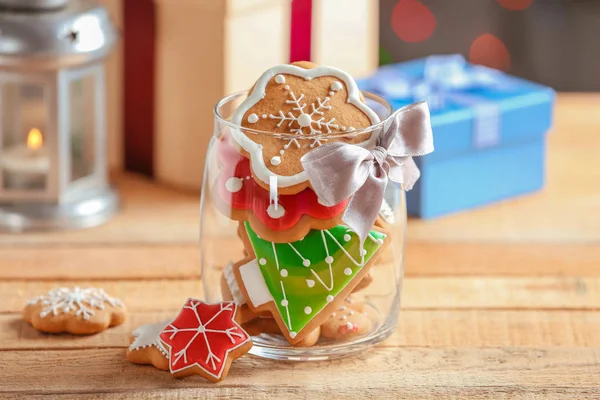 Glass jar with Christmas cookies on wooden table — Stock Photo, Image