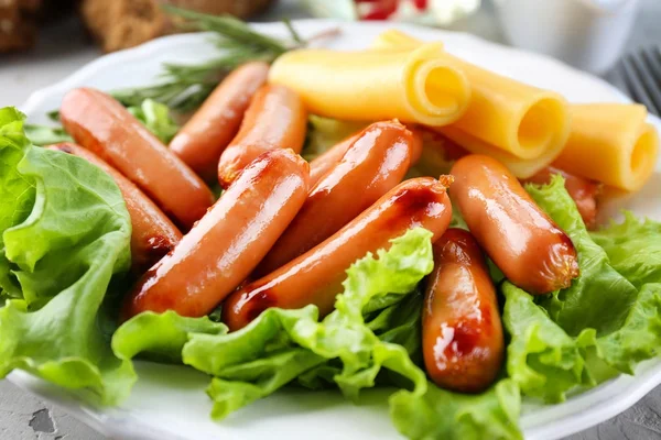 Delicious grilled sausages on plate — Stock Photo, Image