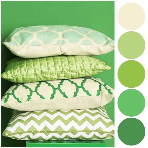 Tavolozza dei colori e cuscini morbidi su sfondo verde — Foto Stock