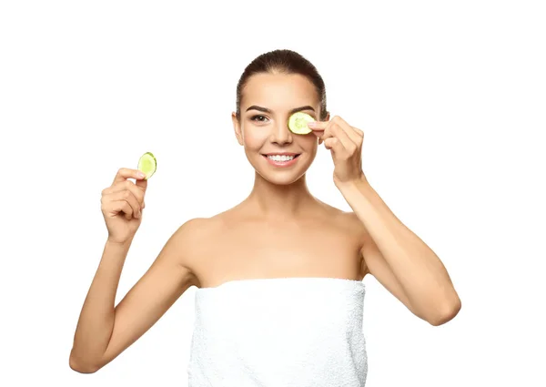 Young woman with cucumber slices on white background — Stock Photo, Image