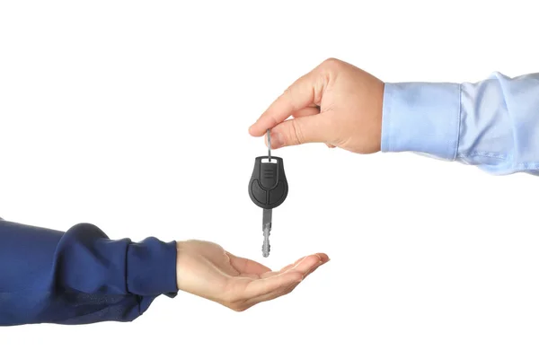 Salesman giving car key to customer on white background — Stock Photo, Image