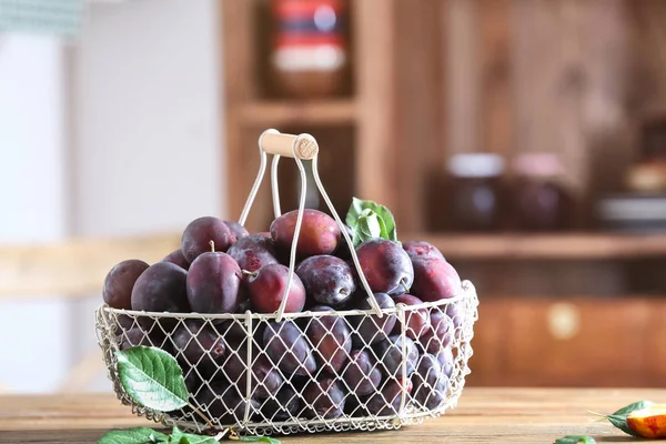 Fresh plums in metal basket — Stock Photo, Image