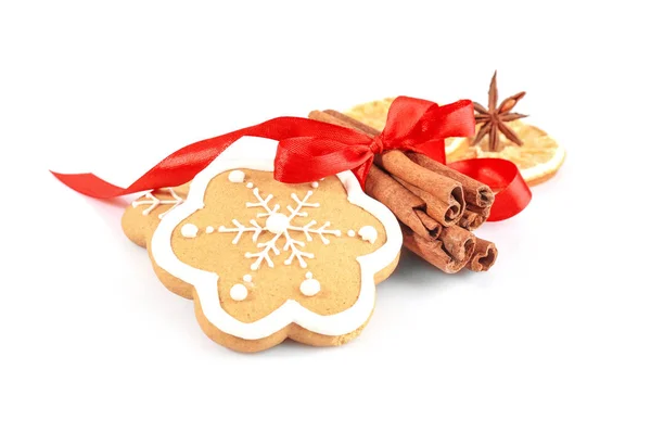 Tasty Christmas cookie and cinnamon on white background — Stock Photo, Image