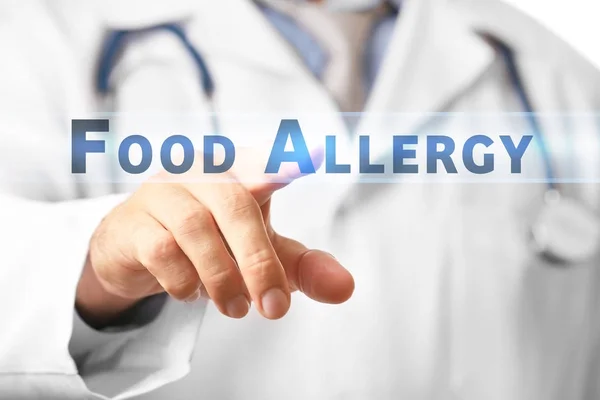 Doctor showing text FOOD ALLERGY on virtual screen