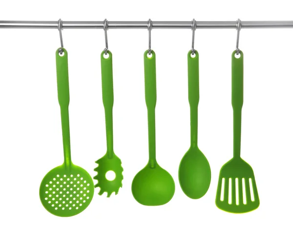 Set of cooking utensils hanging on rack — Stock Photo, Image