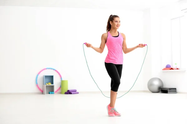 Young woman with skipping rope in gym — Stock Photo, Image