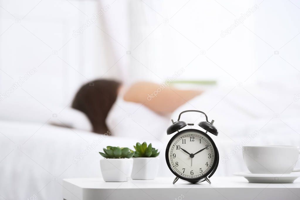 Alarm clock on table in bedroom