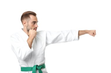Young man practicing karate on white background clipart