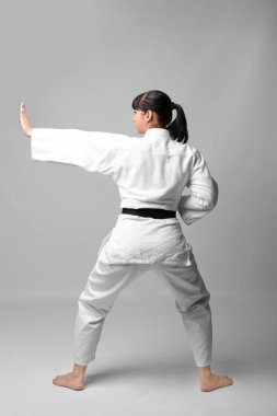 Young woman practicing karate  clipart