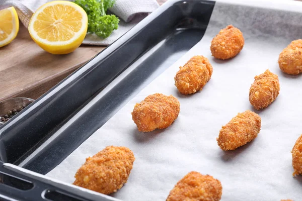 Delicious salmon croquettes in baking tray — Stock Photo, Image