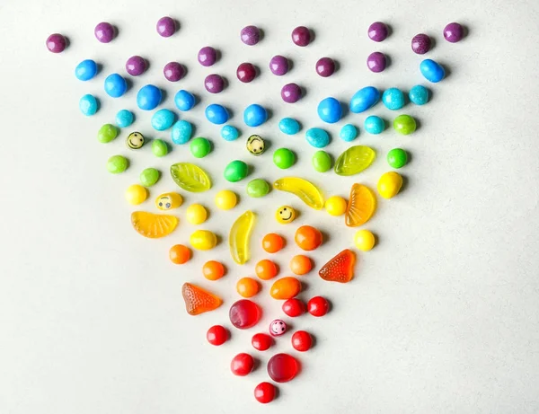 Colorful candies arranged as triangle — Stock Photo, Image