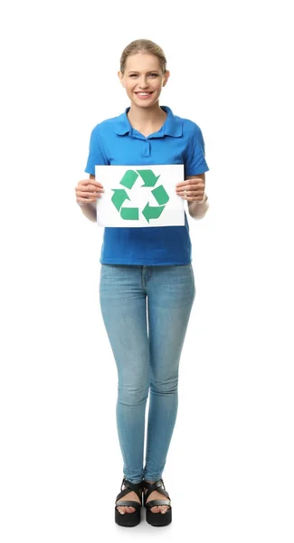 Young woman holding paper sheet with recycling symbol on white background — Stock Photo, Image